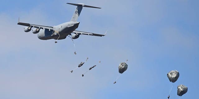 U.S. paratroopers from the 4th Infantry Brigade Combat Team (Airborne), 25th Infantry Division, descend to the drop zone after making a jump from a C-17 Globemaster as part of exercise Talisman Sabre 21 July 28, 2021, in Charters Towers, Australia. 