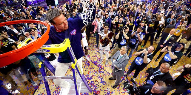 Kansas Jayhawks head coach Bill Self cuts down the net after defeating the North Carolina Tar Heels during the second half of the 2022 NCAA Men's Basketball Tournament National Championship game at Caesars Superdome on April 4, 2022 in New Orleans