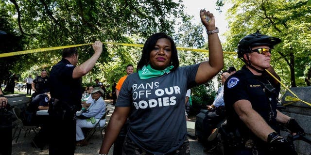 Rep. Cori Bush leaves a processing area after being arrested for participating in a sit-in with activists