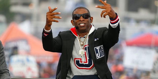 Coach Deion Prime Sanders talks with ESPN commentators before the Jackson State Tigers and Southern University Jaguars NCAA Division I Football Championship Subdivision game at Mississippi Veterans Memorial Stadium on Oct. 29, 2022, in Jackson.