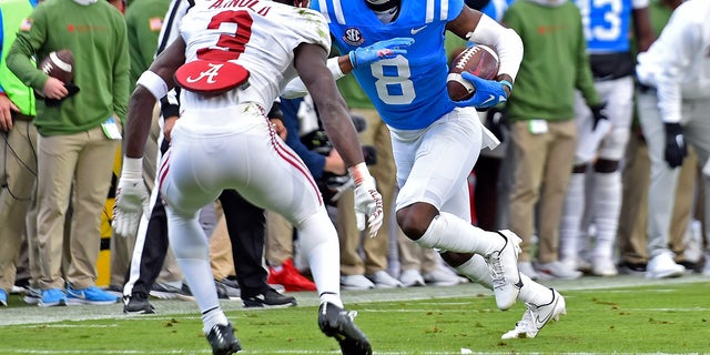 Malik Heath (8) of the Mississippi Rebels carries the ball against Terrion Arnold (3) of the Alabama Crimson Tide during the first half at Vaught-Hemingway Stadium Nov. 12, 2022, in Oxford, Miss.