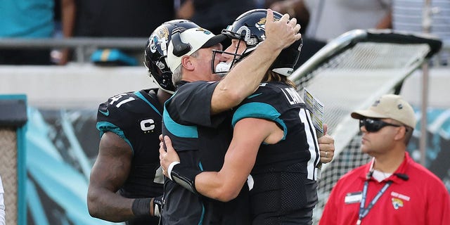 Trevor Lawrence #16 of the Jacksonville Jaguars celebrates a play with head coach Doug Pederson during the second half in the game against the Baltimore Ravens at TIAA Bank Field on November 27, 2022 in Jacksonville, Florida. 