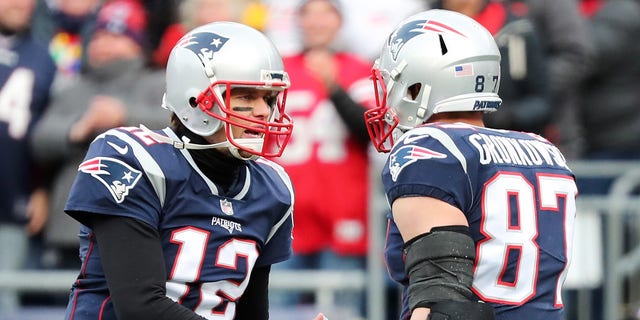 Rob Gronkowski, #87 of the New England Patriots, reacts with Tom Brady, #12, after catching a touchdown pass during the second quarter of a game against the Buffalo Bills at Gillette Stadium on Dec. 24, 2017 in Foxboro, Massachusetts.