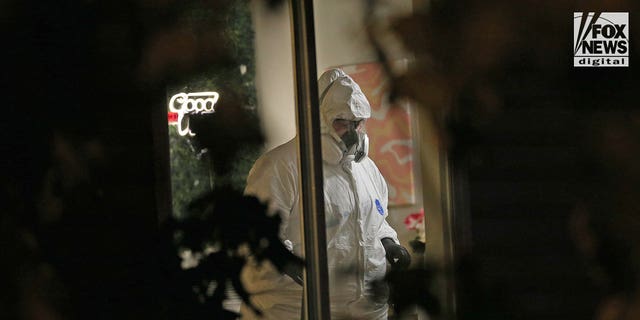 Investigators in hazmat suits examine the scene of a quadruple homicide near the University of Idaho campus.