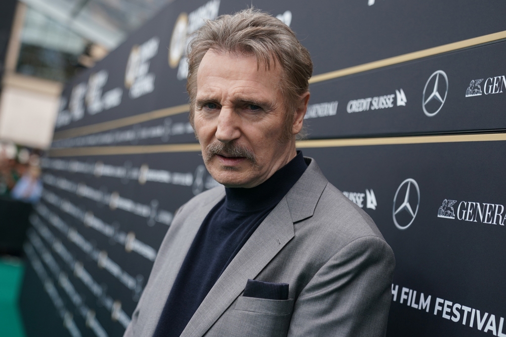 Liam Neeson looking serious at the camera. 