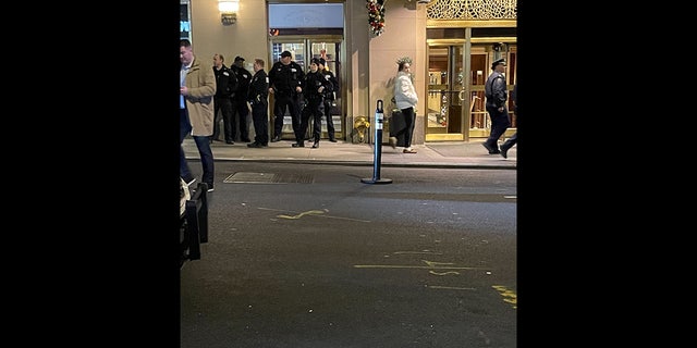 Police stand outside the New York City Hyatt after a possible explosive was found.