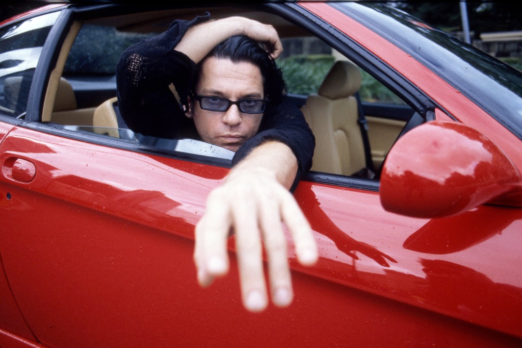 "He was just not the same person," one friend said of the 1992 incident in Copenhagen. Here, Hutchence is photographed in a Ferrari in 1996, a year before his death.