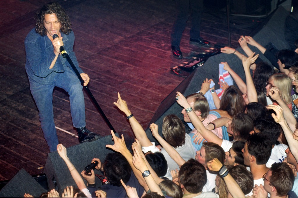 Hutchence playing to the crowd in Belgium in 1991, after the release of their last smash-hit album, 1990's X.