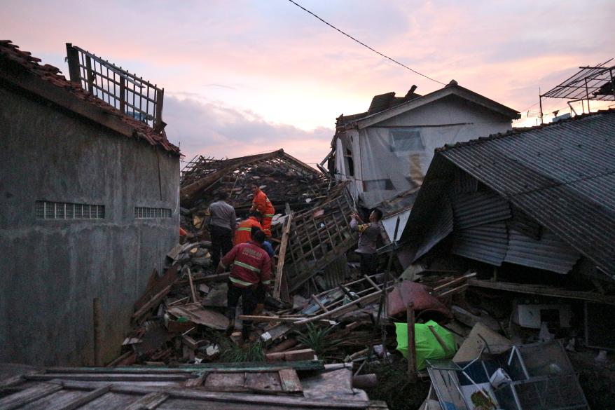 Rescuers search for survivors at the ruins of houses damaged by an earthquake in Cianjur, West Java, Indonesia, on Nov. 21, 2022.