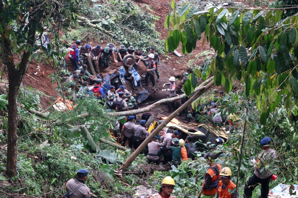 Rescuers remove the wreckages of vehicles damaged in an earthquake-triggered landslide in Cianjur, West Java, Indonesia, on Nov. 21, 2022. 
