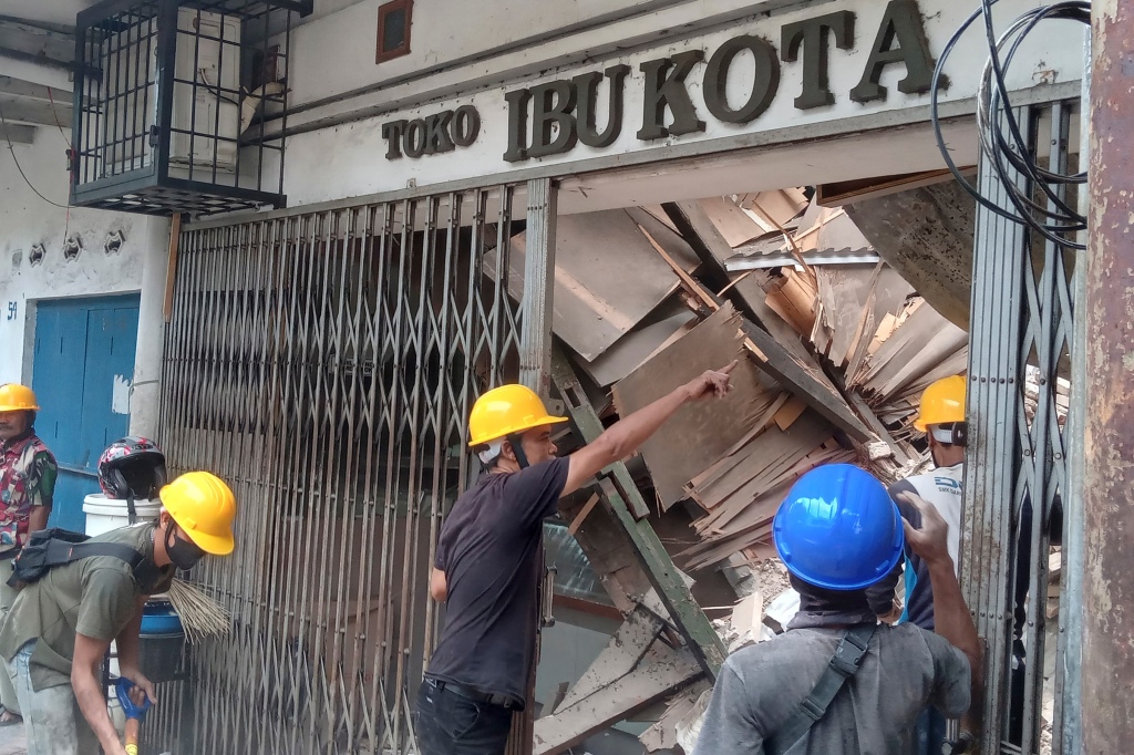 Workers inspect a store that was damaged due to the earthquake in West Java, Indonesia, on Nov. 21, 2022.