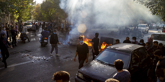 Iranians in Tehran, Oct. 27, 2022, protest the recent death of 22-year-old Mahsa Amini following her arrest by the country's morality police.