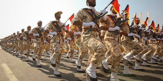 Members of the Iranian revolutionary guard march during a parade to commemorate the anniversary of the Iran-Iraq war