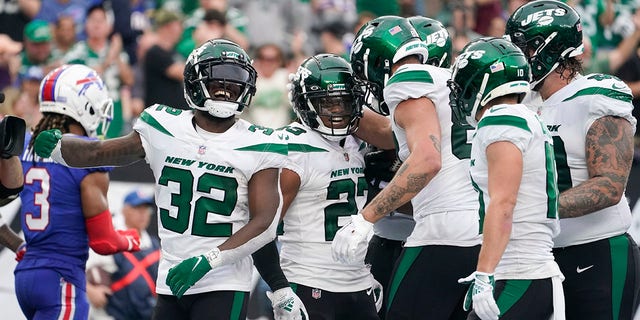 New York Jets running back James Robinson, #23, celebrates with teammates after scoring a touchdown during the second half of an NFL football game against the Buffalo Bills, Sunday, Nov. 6, 2022, in East Rutherford, New Jersey.