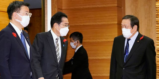 Japan's Prime Minister Fumio Kishida, second left, talks to Defense Minister Yasukazu Hamada, right, as they gather for a cabinet meeting at Kishida's office in Tokyo Friday, Oct. 14, 2022. North Korea early Friday fired an additional ballistic missile and 170 rounds of artillery shells toward the sea and flew warplanes near the tense border with South Korea. "Whatever the intentions are, North Korea's repeated ballistic missile launches are absolutely impermissible and we cannot overlook its substantial advancement of missile technology," Hamada said.  (Keisuke Hosojima/Kyodo News via AP)