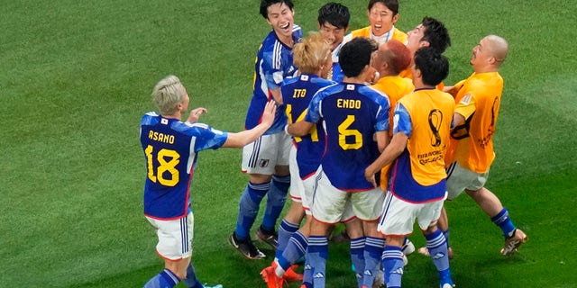 Japan's Takuma Asano celebrates after scoring during the World Cup group E soccer match against Germany in Doha, Qatar, Wednesday, Nov. 23, 2022.