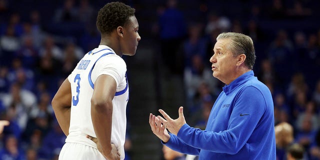 Kentucky's Adou Thiero, left, listens to coach John Calipari during the second half of the team's NCAA college basketball game against North Florida in Lexington, Kentucky, Wednesday, Nov. 23, 2022.