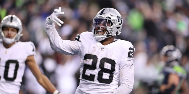 Josh Jacobs (28) of the Las Vegas Raiders celebrates after scoring a touchdown in overtime to beat the Seattle Seahawks at Lumen Field on Nov. 27, 2022, in Seattle, Washington.