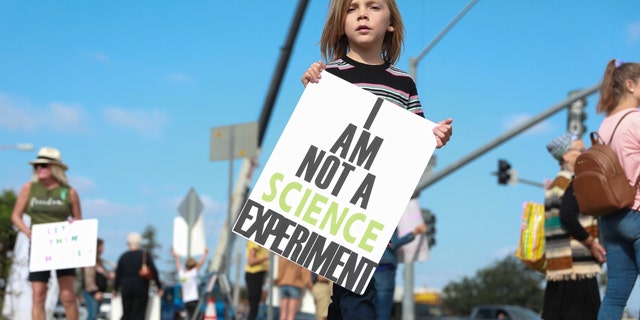 Protesters demonstrate outside the San Diego Unified School District office to protest a forced vaccination mandate for students on Sept. 28, 2021, in San Diego, California.