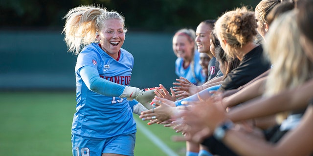 Stanford goalkeeper Katie Meyer shakes hands with teammates before a game