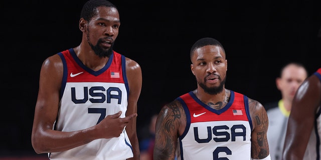 Kevin Durant, left, talks with teammate Damian Lillard during the men's basketball semifinal between the United States and Australia at Tokyo 2020 Olympic Games in Saitama, Japan, on Aug. 5, 2021.