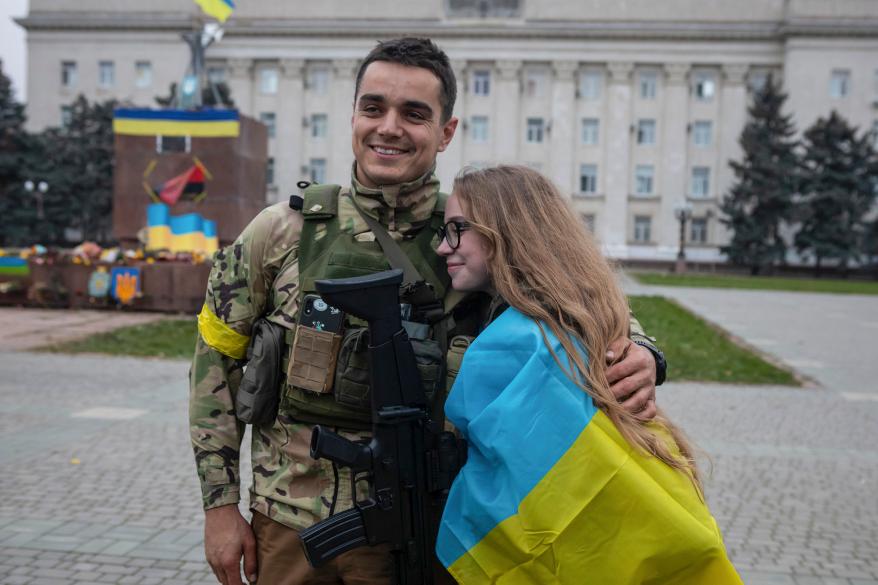 A girl and Ukrainian officer hug as they celebrate the recapturing in Kherson, Ukraine,