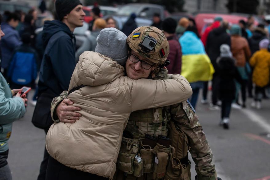 A woman hugs Ukrainian officer as they celebrate the recapturing Kherson