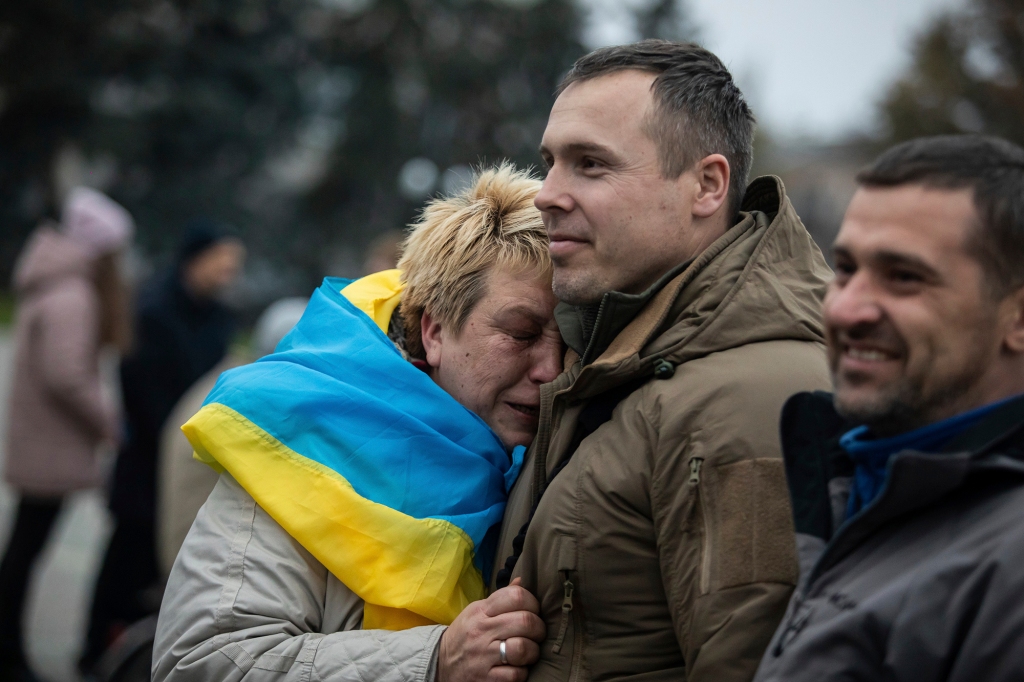 A woman leans on Ukrainian lawmaker and officer Roman Kostenko .