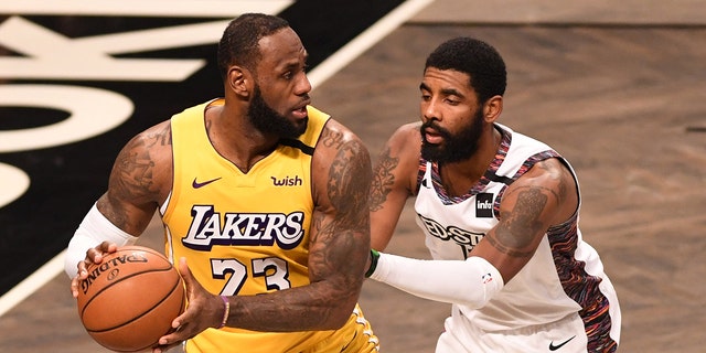 LeBron James, #23 of the Los Angeles Lakers, in action against Kyrie Irving, #11, during the game against the Brooklyn Nets at Barclays Center on January 23, 2020, in New York City.