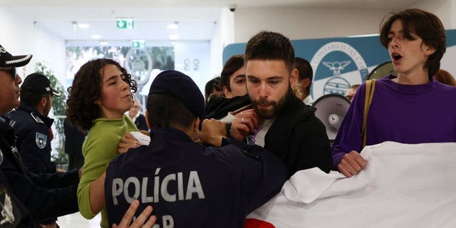 Police officers clash with protesters for climate change.