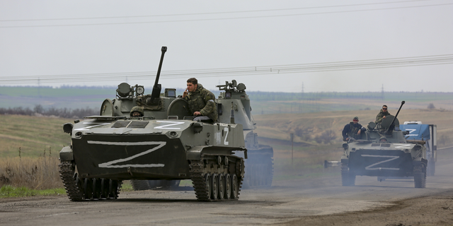 Russian military vehicles move on a highway in an area controlled by Russian-backed separatist forces near Mariupol, Ukraine, in late April.