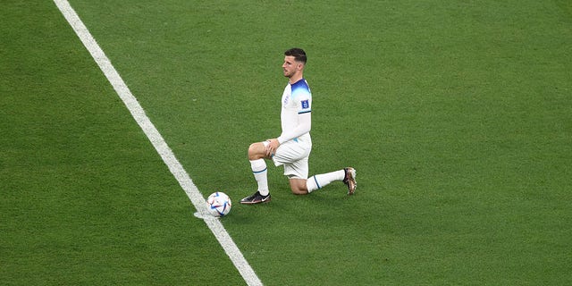 Mason Mount of England takes a knee before a FIFA World Cup Qatar 2022 Group B match against the U.S. at Al Bayt Stadium Nov. 25, 2022, in Al Khor, Qatar.