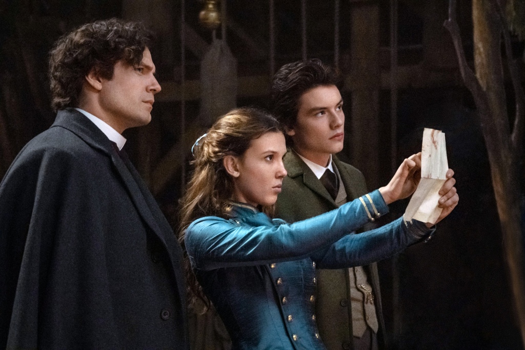 (Left to right) Henry Cavill, Millie Bobby Brown, and  Louis Partridge, in "Enola Holmes 2." 