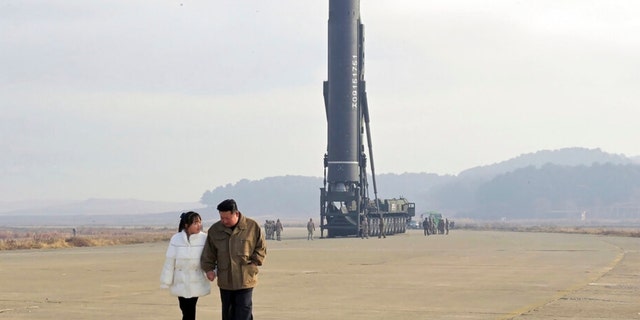 This photo provided on Nov. 19, 2022, by the North Korean government shows North Korean leader Kim Jong Un, right, and his daughter at the site of a missile launch at Pyongyang International Airport in Pyongyang, North Korea, Friday, Nov. 18, 2022. 