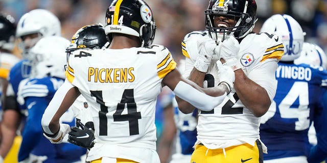 Pittsburgh Steelers running back Najee Harris (22) celebrates a touchdown run with George Pickens (14) during the first half of an NFL football game against the Indianapolis Colts, Monday, Nov. 28, 2022, in Indianapolis.