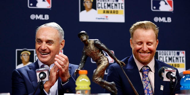 Commissioner of Baseball Robert D. Manfred Jr. and Roberto Clemente Award winner Justin Turner of the Los Angeles Dodgers speak to the media prior to Game Three of the 2022 World Series at Citizens Bank Park on October 31, 2022 in Philadelphia, Pennsylvania