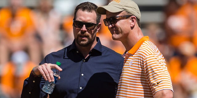 Peyton Manning, right, and Ryan Leaf talk before a college football game between the Tennessee Volunteers and Georgia State Panthers on Aug. 31, 2019, at Neyland Stadium in Knoxville, Tennessee.