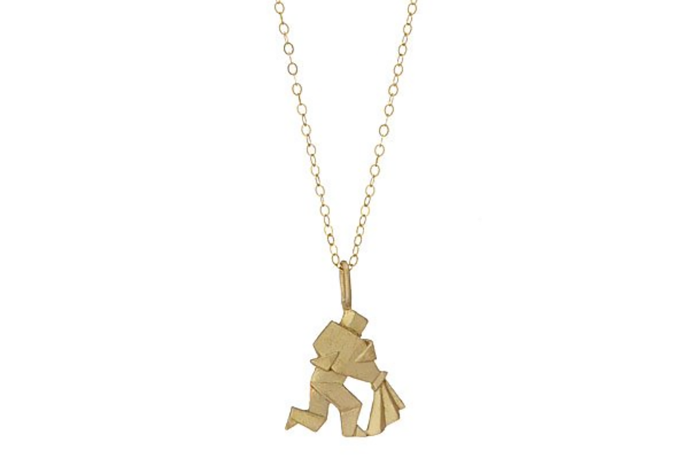 A gold necklace with a origami man 
