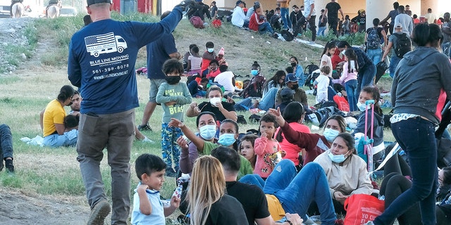 Migrants are seen at the Rio Grande near the Del Rio-Acuna Port of Entry in Del Rio, Texas, on September 18, 2021. Texas' Operation Lone Star was launched to combat illegal immigration and crime at the border. 