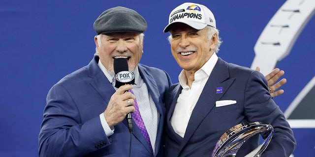 Los Angeles Rams owner Stan Kroenke speaks to Terry Bradshaw while holding the George Halas Trophy after defeating the San Francisco 49ers in the NFC championship game at SoFi Stadium Jan. 30, 2022, in Inglewood, Calif.