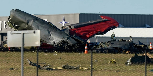 Debris from two planes that crashed during an airshow at Dallas Executive Airport lie on the ground Saturday.