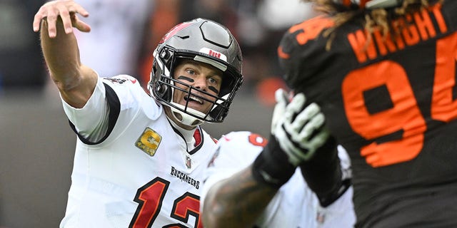 Tampa Bay Buccaneers quarterback Tom Brady gets off a pass under pressure by Browns defensive end Alex Wright in Cleveland, Sunday, Nov. 27, 2022.