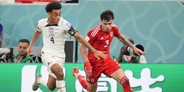 Tyler Adams (4) of the United States chases after a loose ball during a FIFA World Cup Qatar 2022 Group B match between Wales and USMNT at Ahmad Bin Ali Stadium Nov. 21, 2022, in Doha, Qatar.