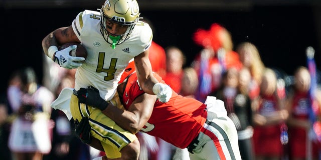 Georgia Tech running back Dontae Smith (4) is stopped by Georgia linebacker Jamon Dumas-Johnson (10) during the first half of an NCAA college football game Saturday, Nov. 26, 2022 in Athens, Ga.