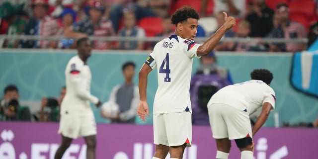 Tyler Adams (4) of the United States acknowledges coaches during a FIFA World Cup Qatar 2022 Group B match against Wales at Ahmad Bin Ali Stadium Nov. 21, 2022 in Doha, Qatar.