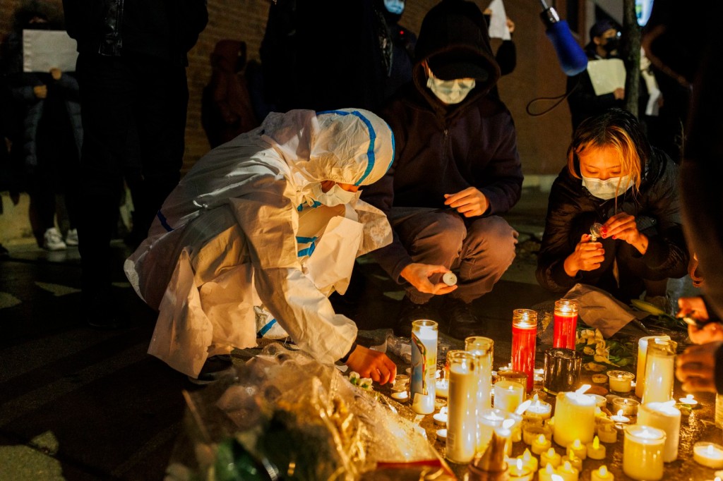 Activists light candles outside the Chinese consulate in Chicago during a rally to support protesters in China on Nov. 29, 2022. 