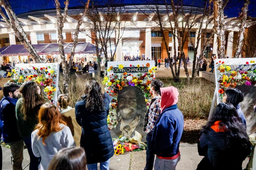 Community members attend a memorial service on Saturday, Nov. 19, 2022, at John Paul Jones Arena