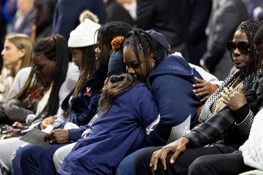 A family member of a shooting victim mourns during a memorial service in Charlottesville, Va., Saturday, Nov. 19, 2022.