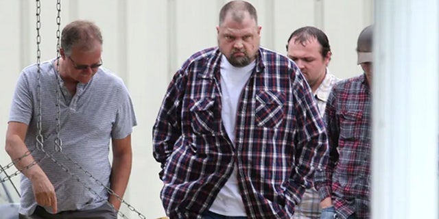 George "Billy" Wagner, center, and his sons George Wagner IV, in back, and Edward "Jake" Wagner, at right, attended the funeral of Gary Rhoden, 38, in Greenup, Ky. 