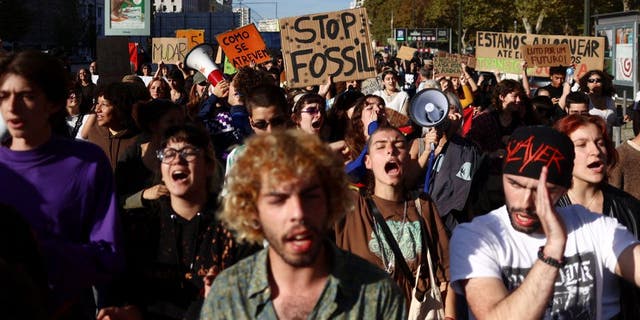 Protesters for climate change and against the use of fossil fuels shout slogans in Lisbon, Portugal, November 12, 2022.